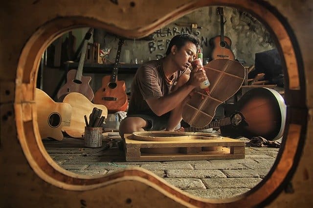 workshop men making guitar