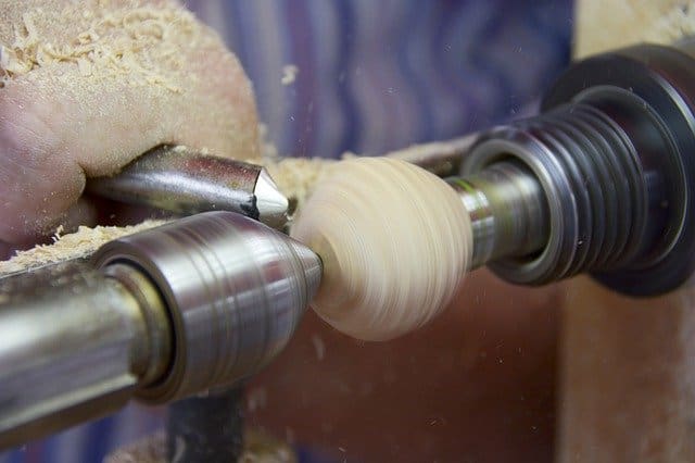 lathe spindle rotating with a small wood on it.