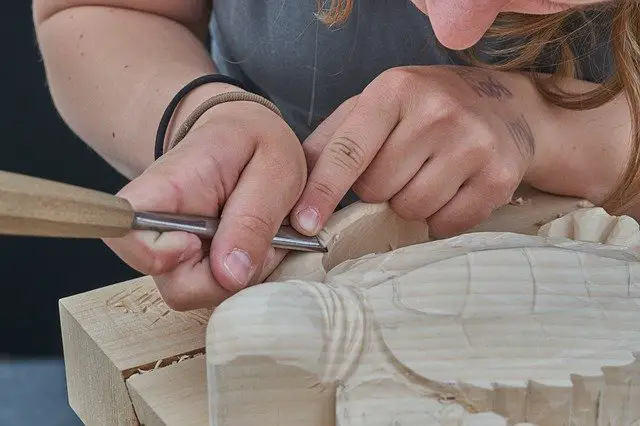 A woodcarver chiseling a sculpture