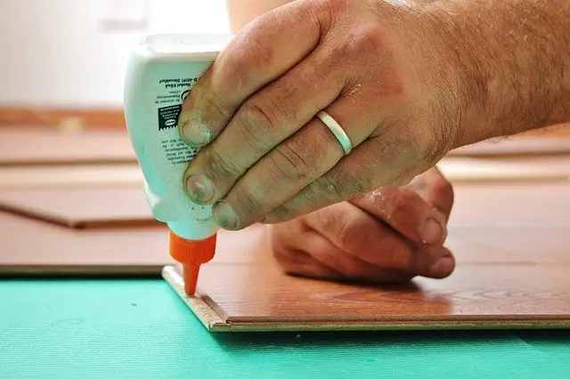 Wood glue being applied to flooring