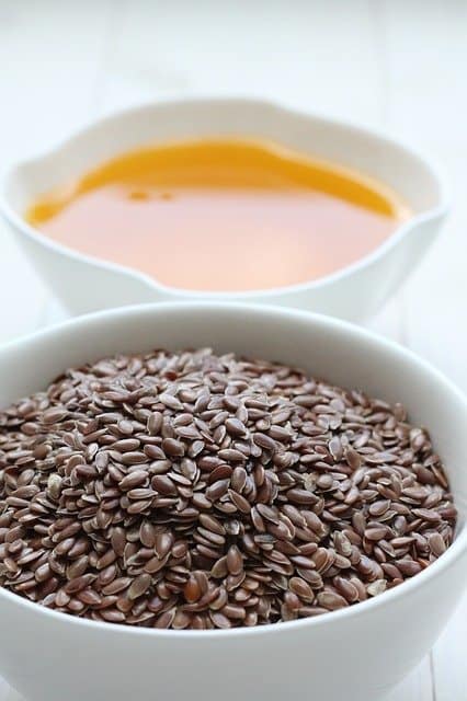 linseed oil next to a bowl of Linseeds