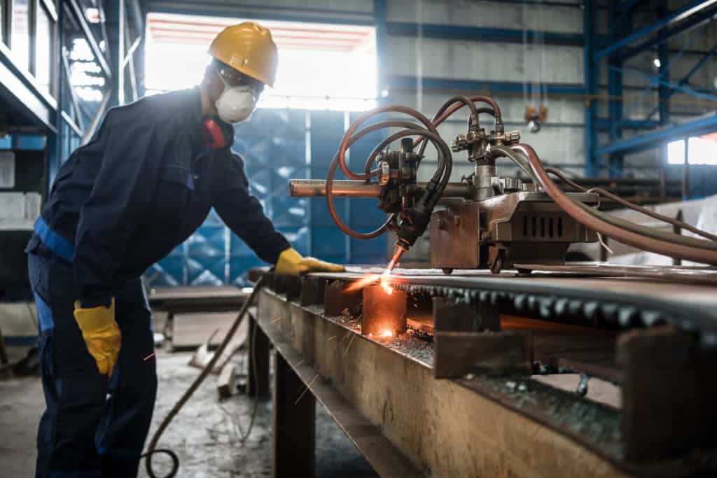 Man standing next to a cnc cutter