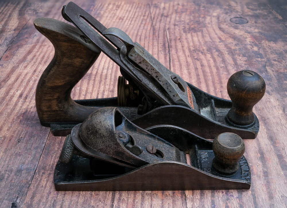 Two Stanley planes on a wooden work surface