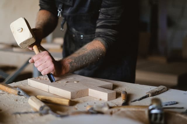 Man using a mallet and chisel