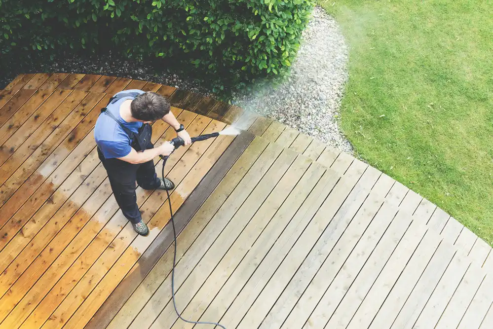 Man-cleaning-decking-terrace-with-a-power-washer