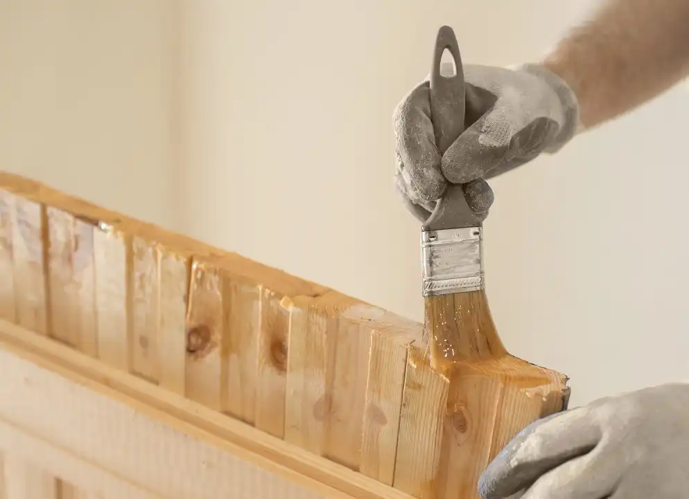 a-man-varnishes-a-wooden-board-with-a-brush