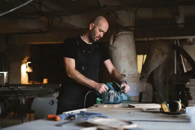 man-using-a-belt-sander