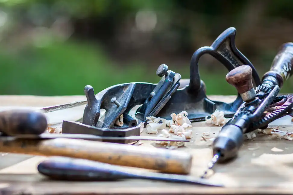 Hand planer hand drill on a table