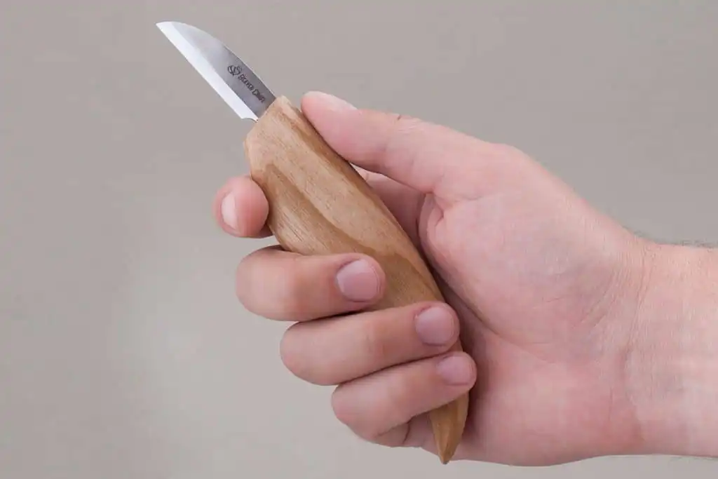 someone holding the Beavercraft C2 Wood Carving Bench Knife in their hand 