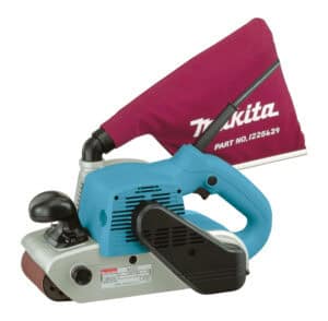 Handheld belt sander removing old varnish from pine plank